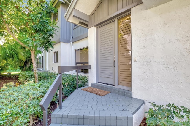 doorway to property with stucco siding