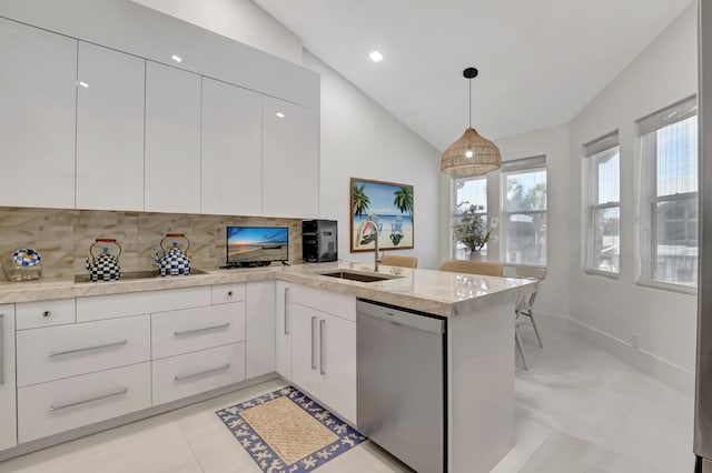 kitchen with stainless steel dishwasher, a sink, and white cabinetry