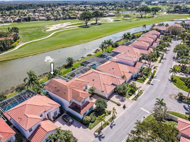 birds eye view of property with a residential view, a water view, and golf course view