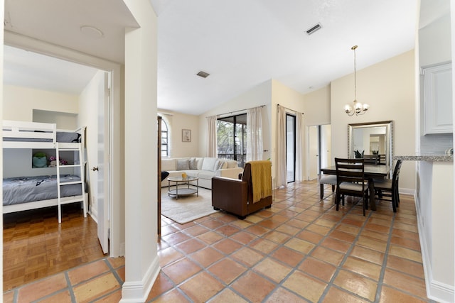 living area with visible vents, vaulted ceiling, baseboards, and an inviting chandelier