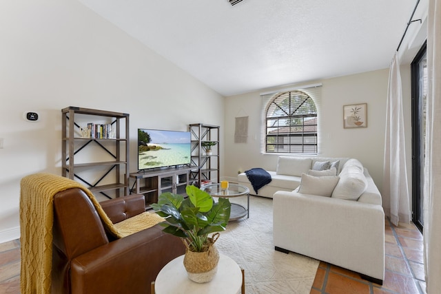 living room featuring lofted ceiling and light tile patterned flooring