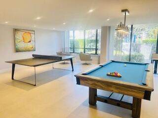 recreation room with recessed lighting and a wall of windows