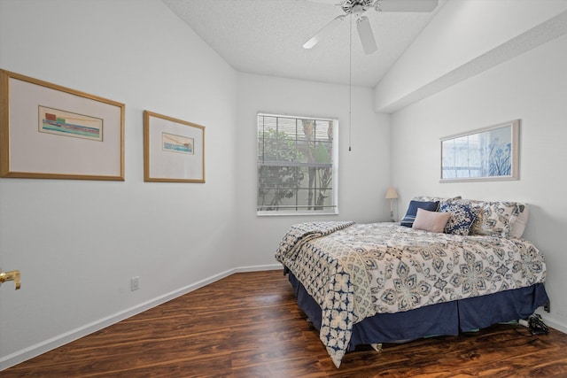 bedroom with lofted ceiling, a textured ceiling, wood finished floors, and baseboards