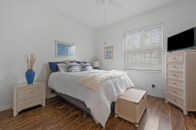 bedroom with ceiling fan, baseboards, and wood finished floors