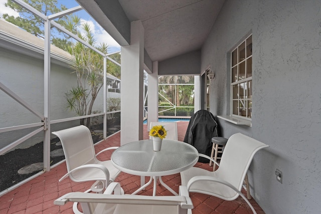 exterior space featuring outdoor dining space, a lanai, and an outdoor pool