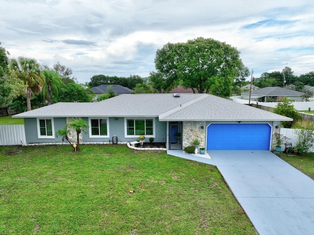 single story home featuring an attached garage, driveway, a front lawn, and fence