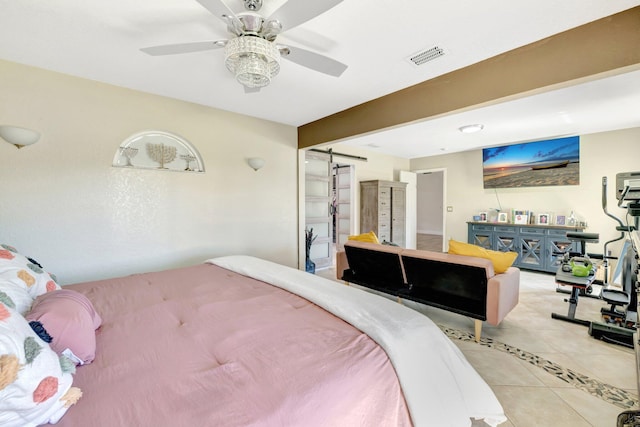 bedroom with a barn door, light tile patterned flooring, a ceiling fan, and visible vents
