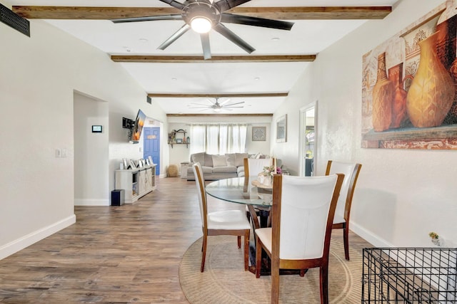 dining room with visible vents, wood finished floors, baseboards, and ceiling fan