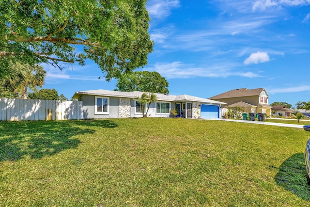 ranch-style home with a front yard, fence, a garage, and stone siding