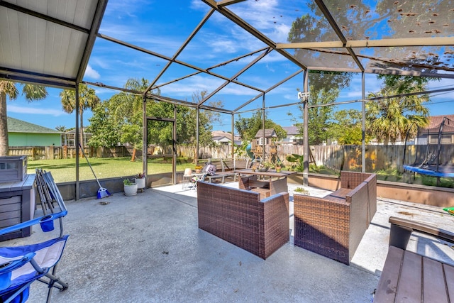 view of patio / terrace featuring a fenced backyard, an outdoor hangout area, a lanai, and a trampoline