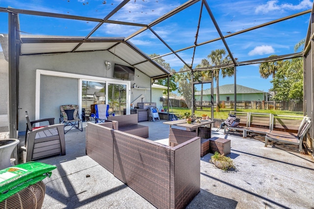 view of patio with an outdoor living space, glass enclosure, and fence