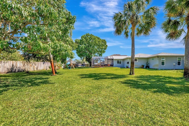 view of yard with a playground and fence
