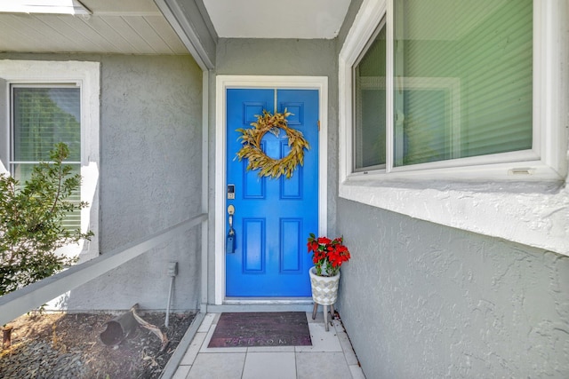 property entrance featuring stucco siding