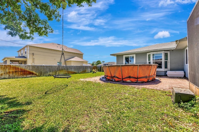 view of yard featuring a pool and fence