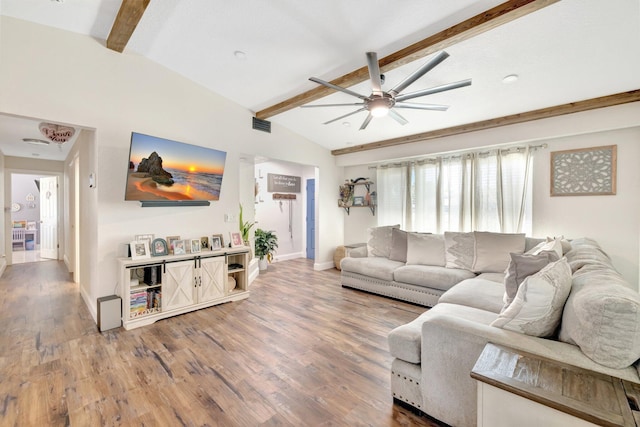 living room with visible vents, lofted ceiling with beams, baseboards, and wood finished floors