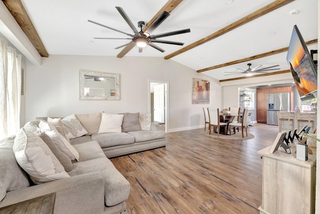 living room with lofted ceiling with beams, light wood-type flooring, baseboards, and ceiling fan