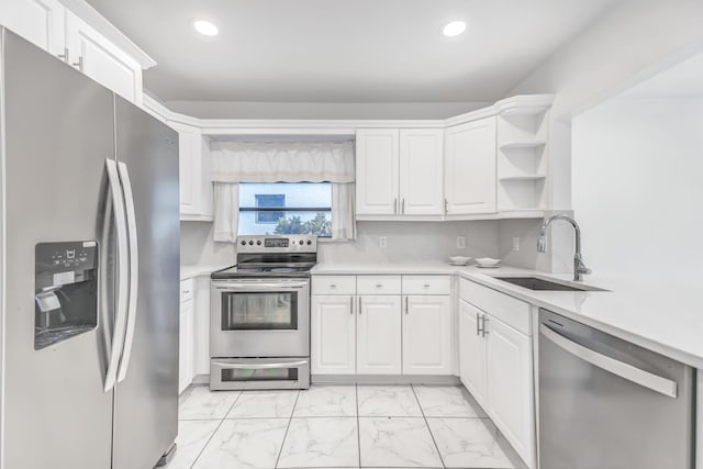 kitchen with marble finish floor, open shelves, light countertops, appliances with stainless steel finishes, and a sink