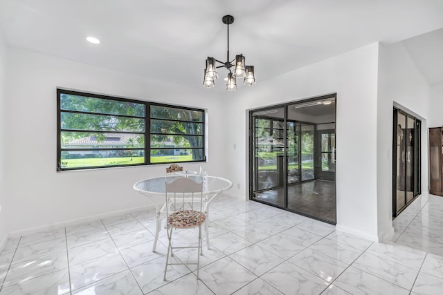 unfurnished dining area with marble finish floor, baseboards, and a notable chandelier