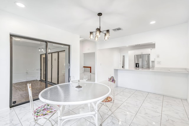 dining area with marble finish floor, recessed lighting, visible vents, and an inviting chandelier