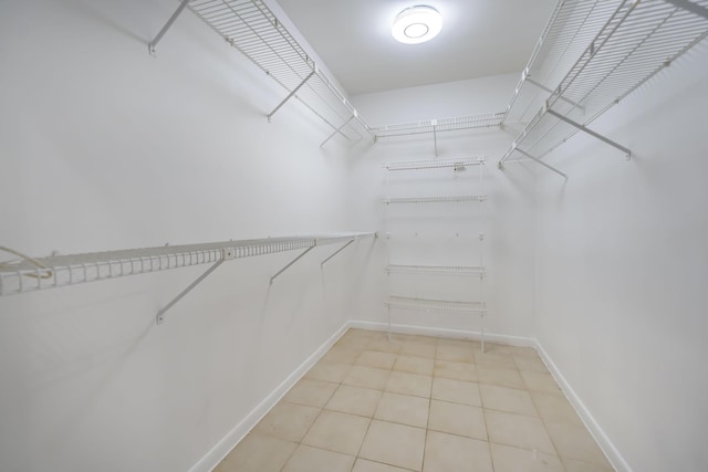 spacious closet with light tile patterned floors