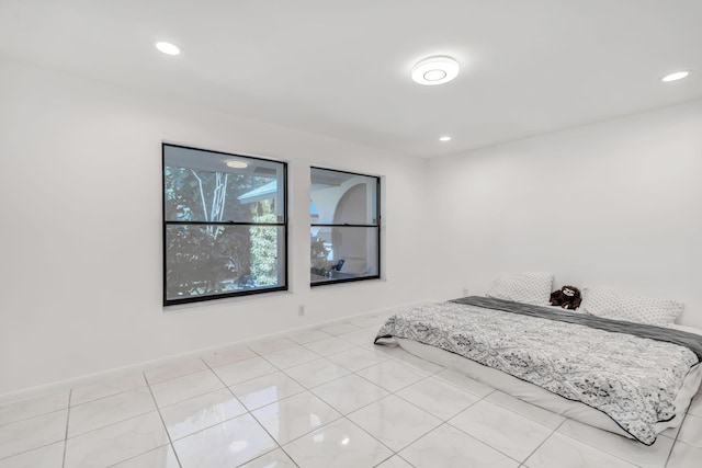 bedroom featuring light tile patterned floors, baseboards, and recessed lighting