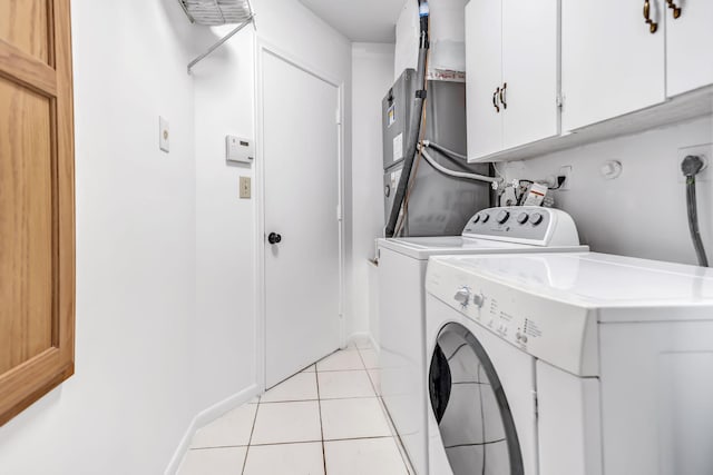 laundry room featuring cabinet space, washer and clothes dryer, and light tile patterned flooring