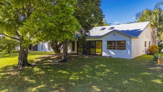 view of front of house featuring a front lawn and stucco siding