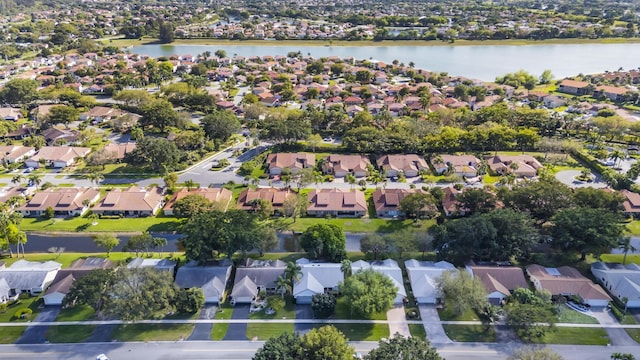 bird's eye view featuring a water view and a residential view