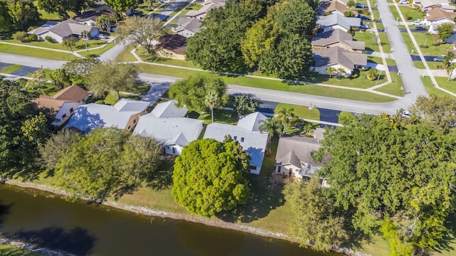 birds eye view of property with a water view and a residential view