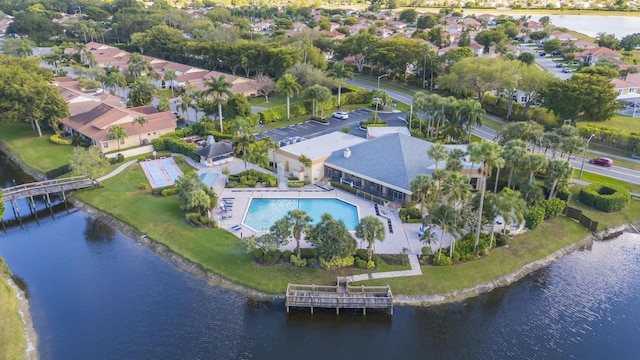 birds eye view of property with a water view and a residential view