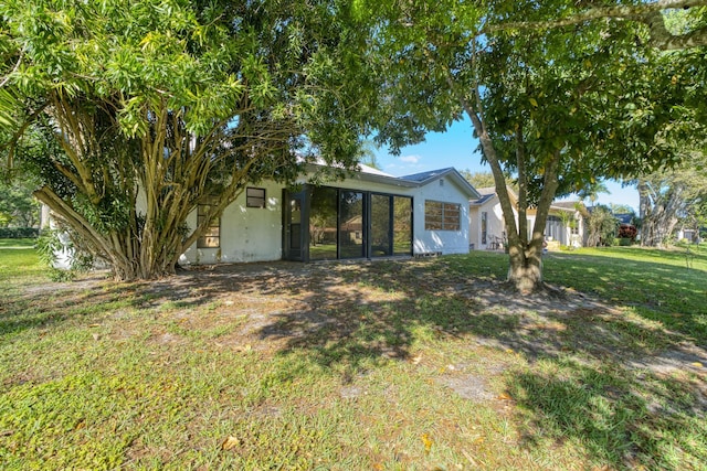 view of front of house featuring a front yard and stucco siding