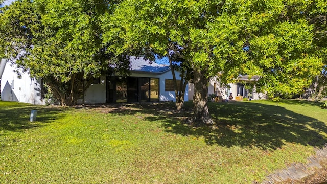 obstructed view of property with a front yard