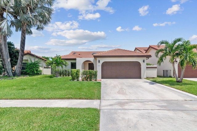 mediterranean / spanish-style house with stucco siding, concrete driveway, a front lawn, a garage, and a tiled roof