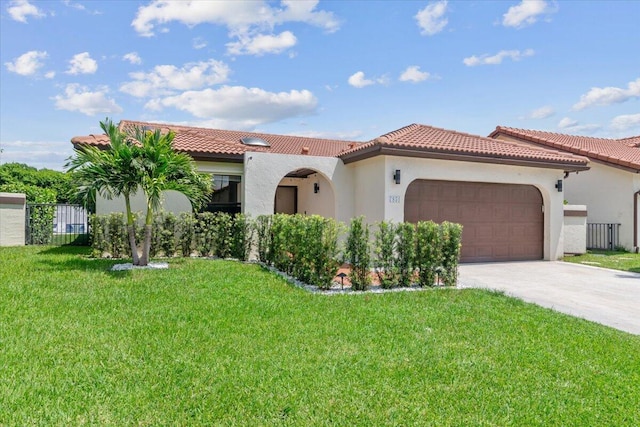 mediterranean / spanish-style home featuring concrete driveway, a garage, a front yard, and stucco siding