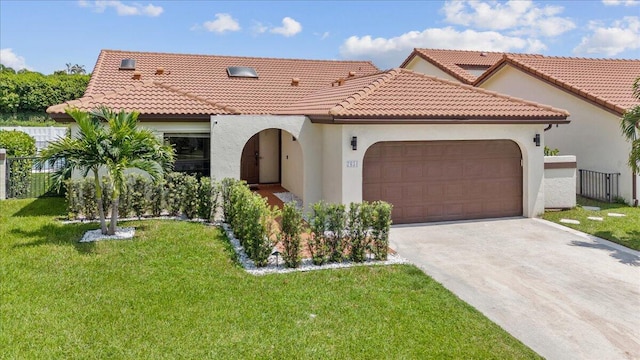 mediterranean / spanish house featuring a tile roof, a garage, driveway, and stucco siding