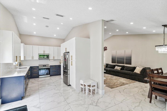 kitchen with blue cabinetry, a sink, stainless steel appliances, light countertops, and open floor plan