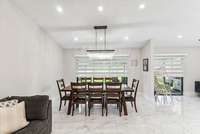 dining area featuring recessed lighting, marble finish floor, a textured ceiling, and baseboards