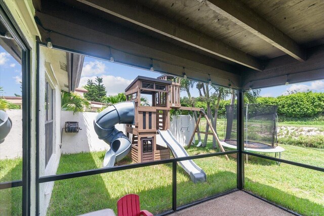 exterior space with a lawn and a trampoline