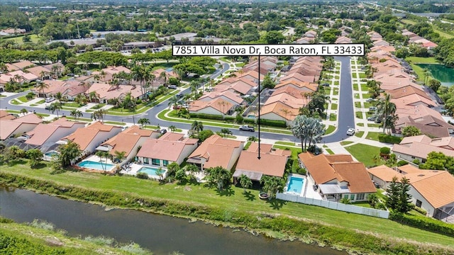 bird's eye view featuring a residential view and a water view