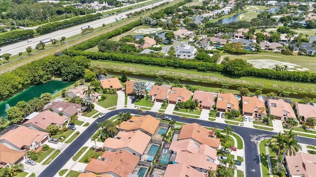 drone / aerial view featuring a residential view and a water view