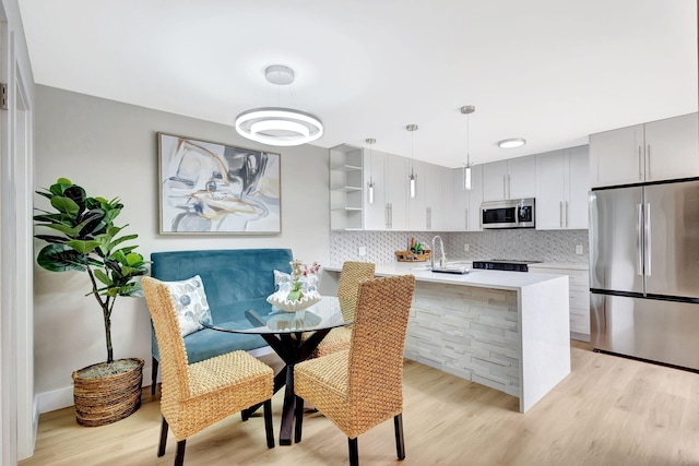 dining area featuring light wood-style flooring