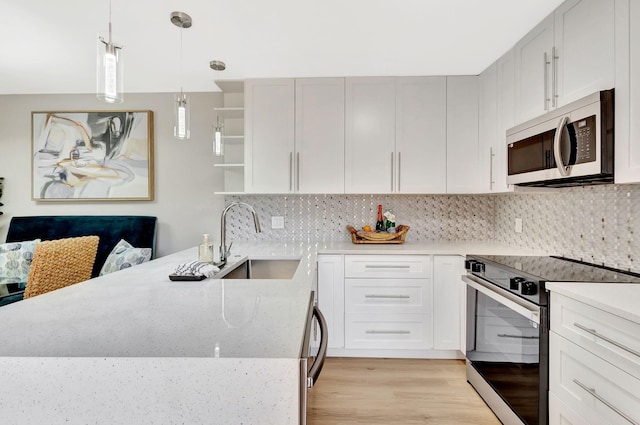 kitchen with electric range, stainless steel microwave, a peninsula, open shelves, and a sink