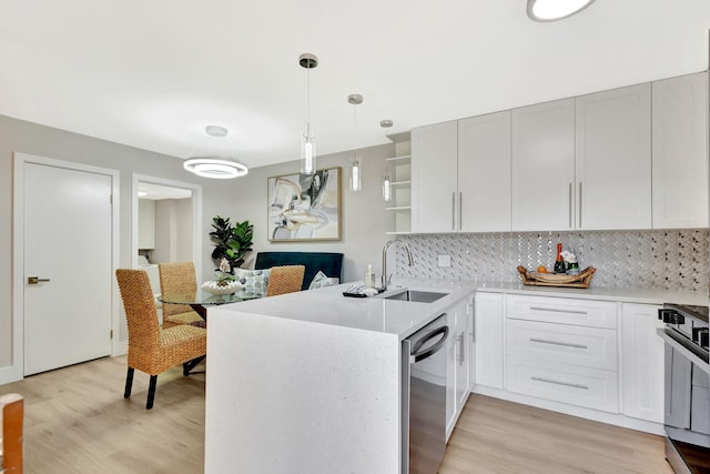 kitchen with a sink, light wood-style flooring, stainless steel dishwasher, and open shelves