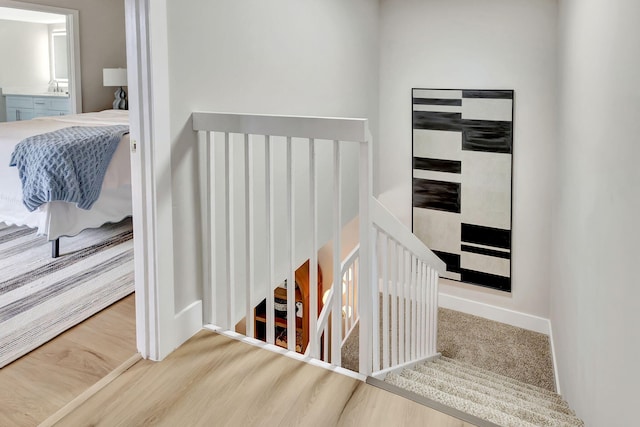 staircase featuring carpet floors and baseboards