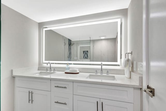 full bathroom featuring a walk in shower, double vanity, and a sink