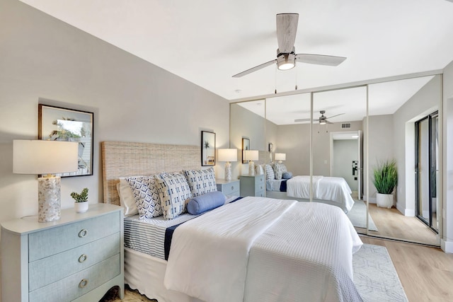 bedroom with visible vents, a ceiling fan, light wood-style flooring, and baseboards