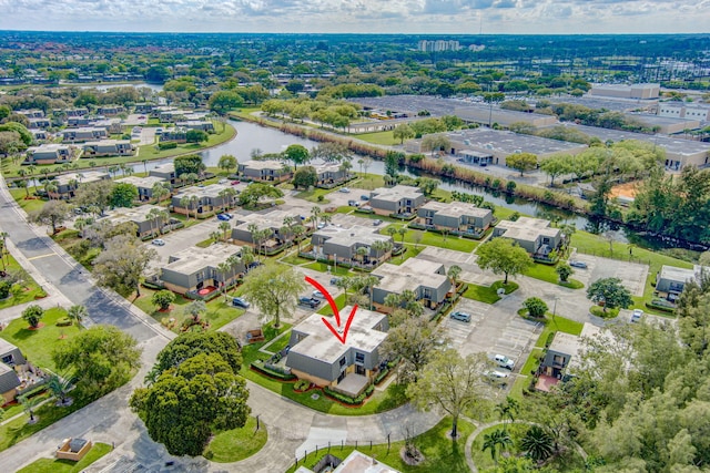 drone / aerial view featuring a residential view and a water view