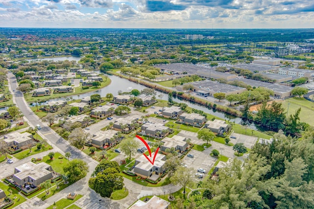 birds eye view of property with a water view and a residential view