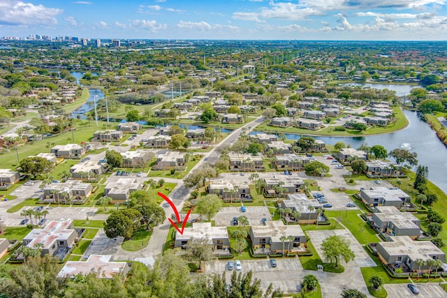 birds eye view of property with a water view and a residential view