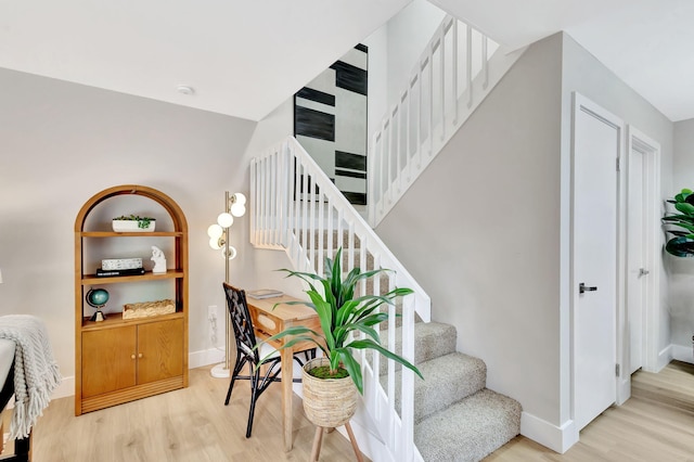 staircase with wood finished floors and baseboards